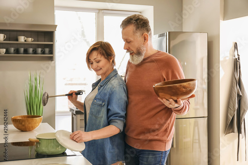 Happy mature couple cooking...