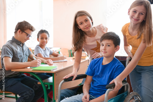Boy in wheelchair with clas...
