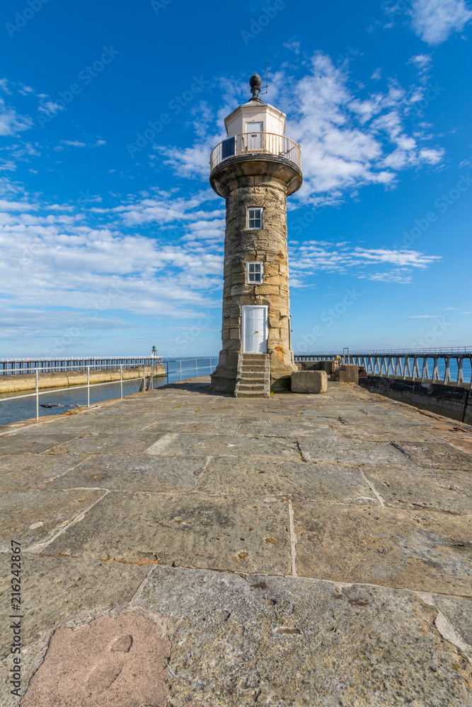 Whitby Lighthouse against blue sky - North Yorkshire, England