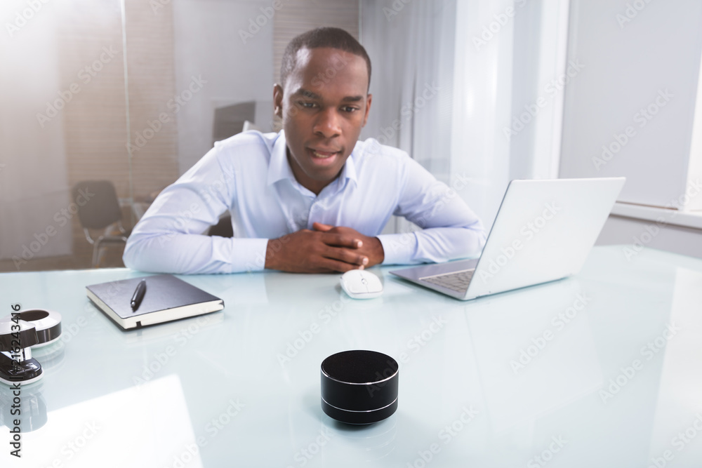 Fototapeta premium Businessman Speaking On Wireless Speaker