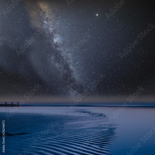 Fototapeta Naklejka Na Ścianę i Meble -  Vibrant Milky Way composite image over landscape of view along beach at low tide