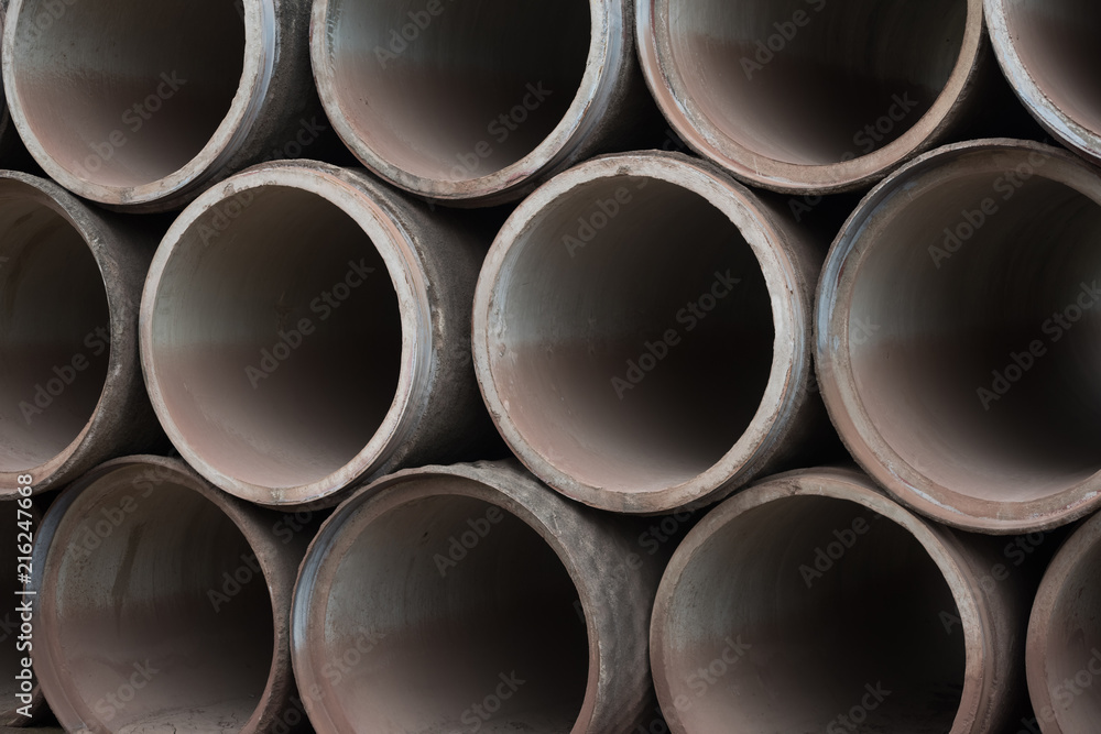 Concrete tubes on cracked muddy ground Concrete tubes on cracked muddy ground