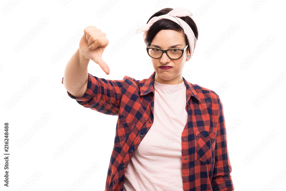 Pretty pin-up girl wearing glasses showing thumb down gesture. Pretty pin-up girl wearing glasses showing thumb down gesture.