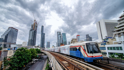 Sky train, mass transportation pass through skycrapers business building in central business district of Bangkok, Thailand