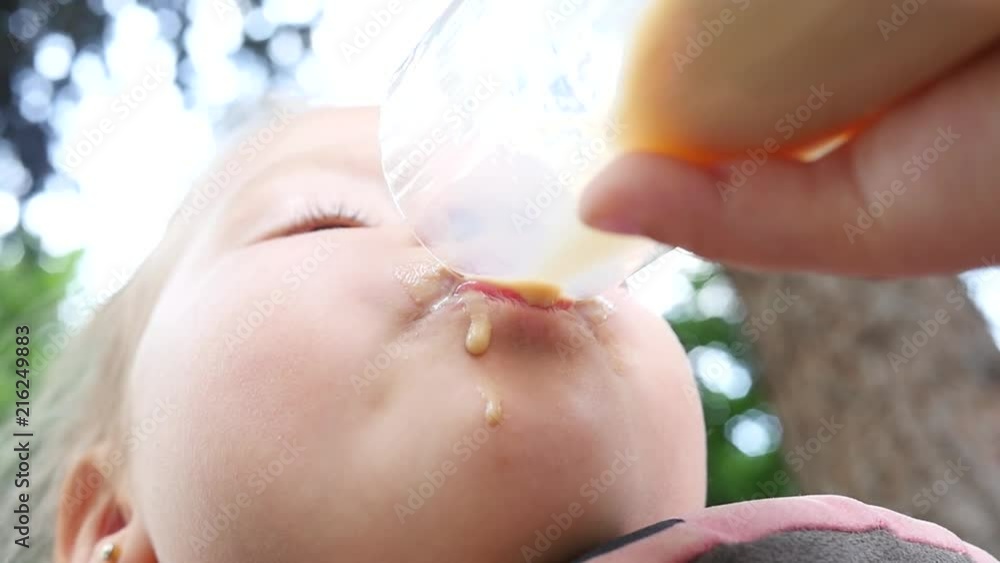 Cocoa and milk drink little child girl funny drinking from a cup - cacao Cocoa and milk drink little child girl funny drinking from a cup - cacao