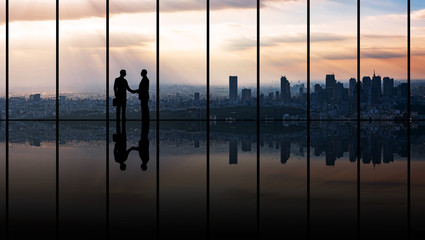 Businesspeople in front of urban cityscape.