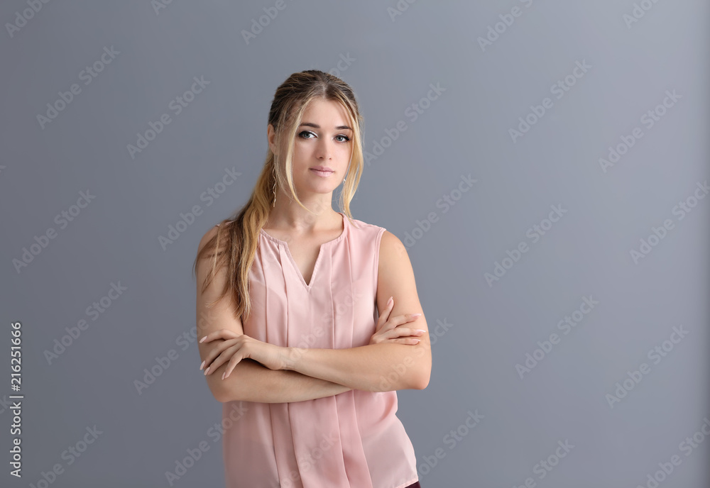 Portrait of attractive young woman on grey background Portrait of attractive young woman on grey background