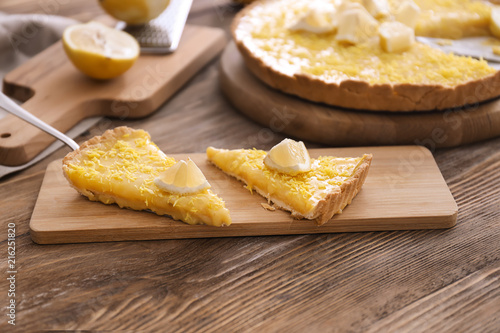 Pieces of tasty lemon pie on wooden table