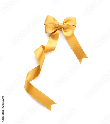 Beautiful bow from golden ribbon on white background