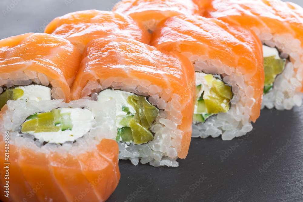 Japanese restaurant, sushi roll on black slate plate. Japanese restaurant, sushi roll on black slate plate.