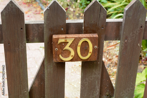 House number 30 sign on gate photo