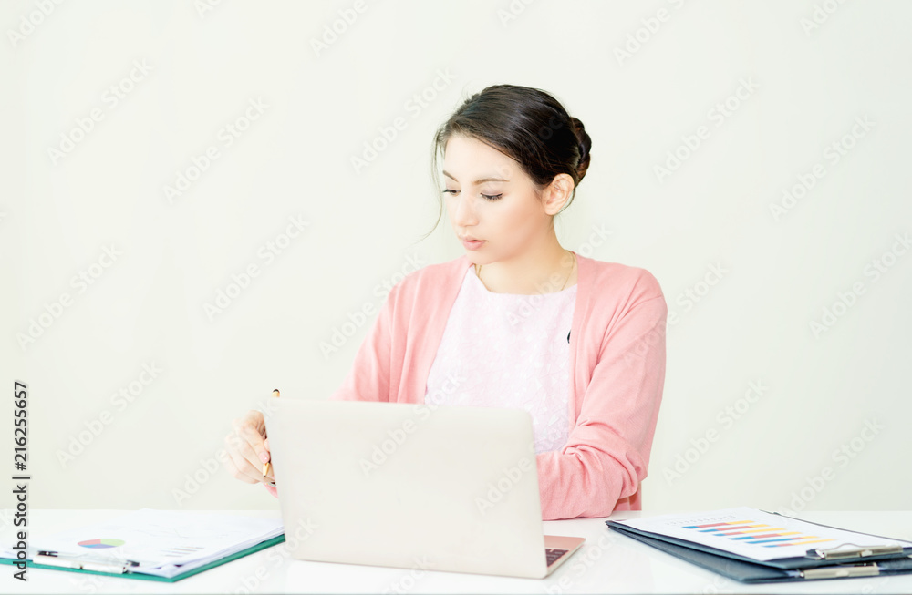 happy young woman working on laptop in workplace.entrepreneur working at start up.Business woman in office start-up working on laptop. happy young woman working on laptop in workplace.entrepreneur working at start up.Business woman in office start-up working on laptop.