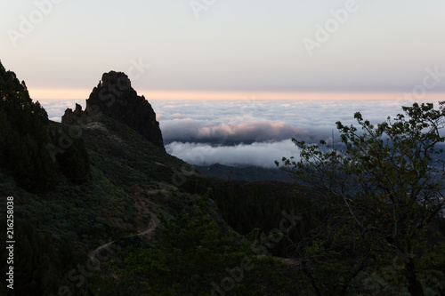 Awesome natural landscape by Pico de las Nieves at sunset in Gran Canaria, Spain. Heavy clouds and twilight above with mountain silhouette in Canary Islands. Travel, hiking, trekking concepts