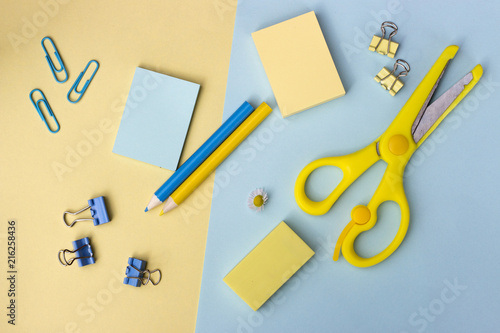 school supplies on a blue and yellow background, Back to school concept, top view, office background.