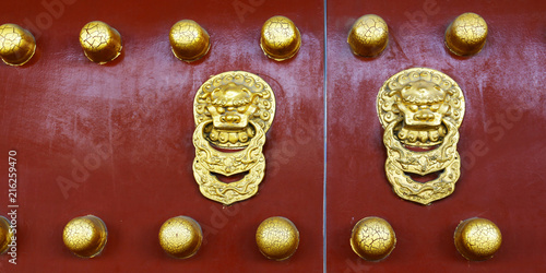 door handle with dragon design on wooden door of buddhist temple