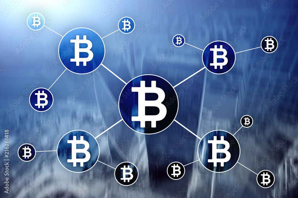 Bitcoin cryptocurrency and blockchain technology concept on blurred skyscrapers background.