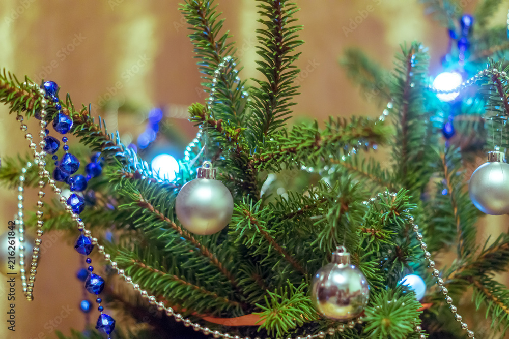 Spruce branches decorated with garlands and balls.
