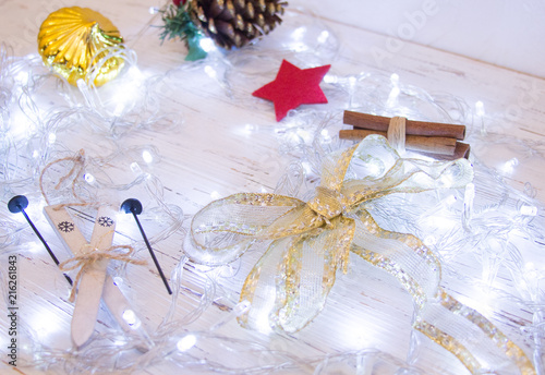 Christmas or New Year background: , colorful glass balls, decoration and glittering stars on white wood, top view, copy space.