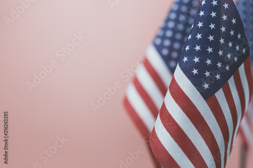 Obraz na płótnie Flags United States of America with vintage pink background empty space for your text on left. w salonie