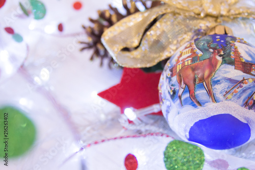 Christmas or New Year background:  colorful glass balls, decoration and glittering stars on white wood, top view, copy space.