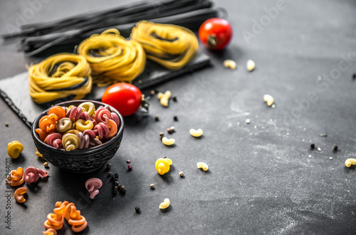 Still life of Italian pasta on grey stone background photo