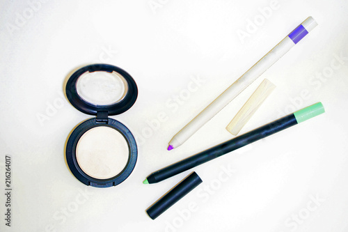 loose powder with mirror and eyeliner or lip pen