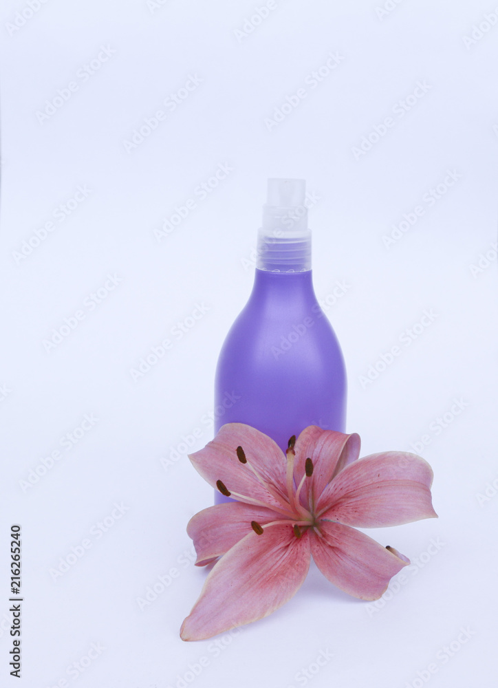 cosmetic set for skin care on a white background with flowers lilies.  composition for Spa, bath, sauna, shower.  lilac shower  shampoo and shower gel  with purple lily for gentle cleansing of  skin