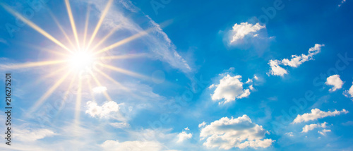 Hot summer or heat wave background, blue sky with glowing sun