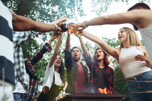 Photography Group of friends making barbecue in the backyard