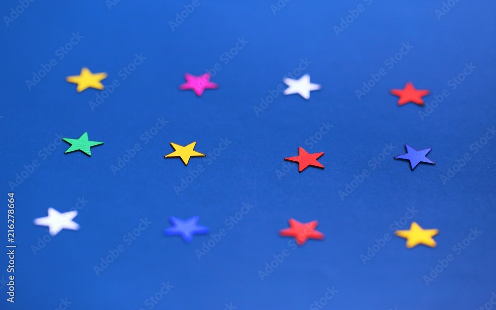 Flat lay of star decorations closeup on blue texture blur background