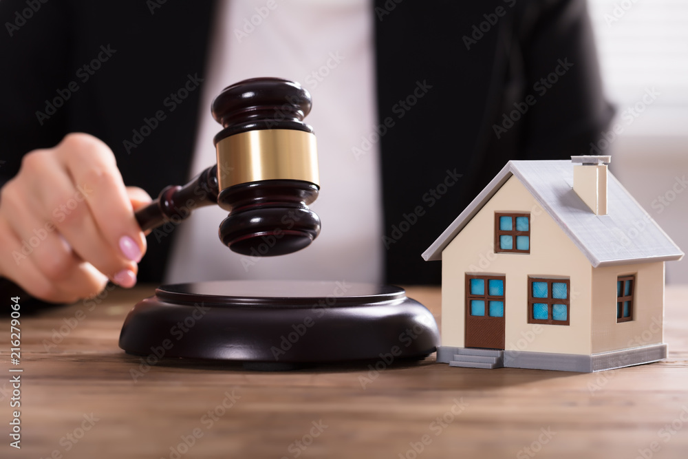 Judge Striking Gavel Near House Model Judge Striking Gavel Near House Model