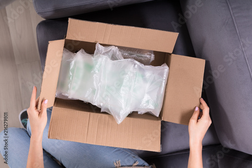 Woman Opening Delivered Parcel