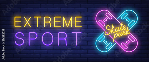 Extreme sport, skate park neon style banner. Text and crossed skateboards on brick background. Night bright advertisement. Can be used for signs, posters, billboards