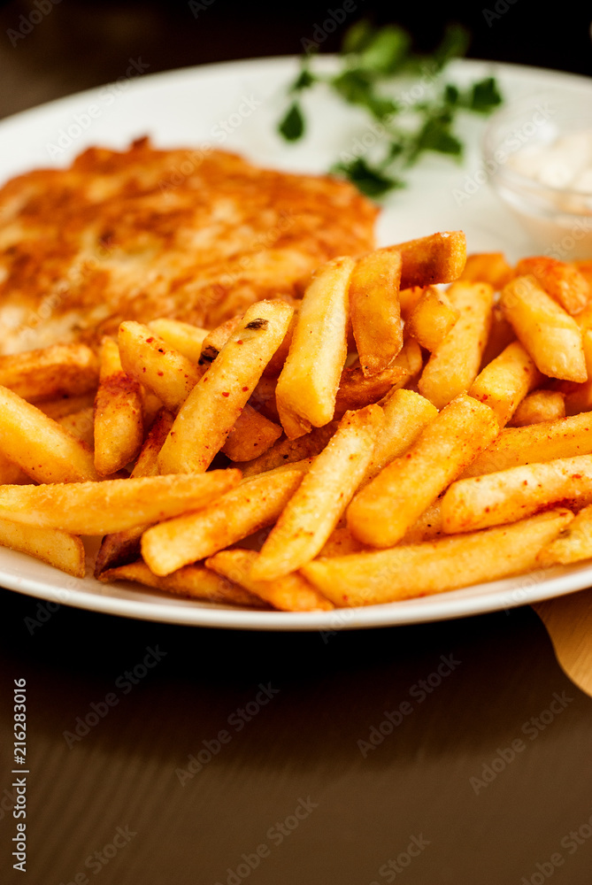 Vienna schnitzel and French fries. Traditional Austrian dish. Vienna schnitzel and French fries. Traditional Austrian dish.