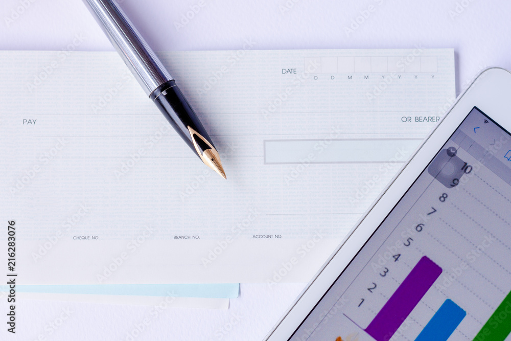 cheque book, pen and digital tablet isolated on white background. cheque book, pen and digital tablet isolated on white background.