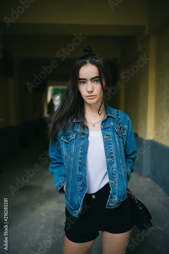 Teen girl standing in tunnel during walk in city
