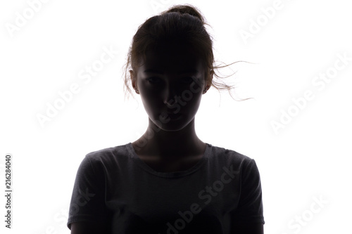 silhouette of a serious and confident young woman looking straigh on a white isolated background