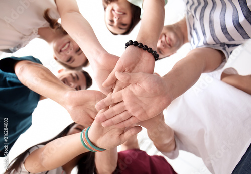 People putting hands togeth...