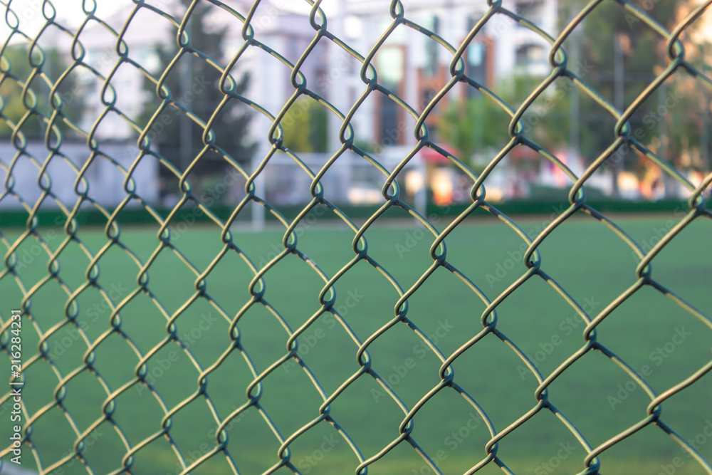Fototapeta premium Close-up detail green color soccer area wires
