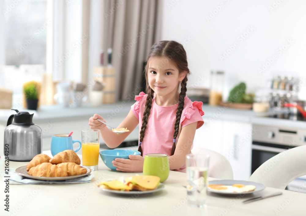Little girl having breakfast in kitchen Little girl having breakfast in kitchen
