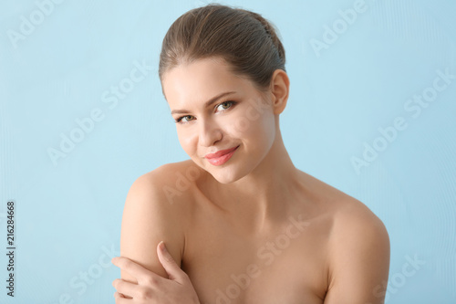 Young woman applying cream ...