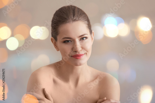 Young woman applying cream ...