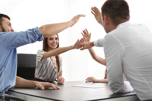 Young people putting hands ...