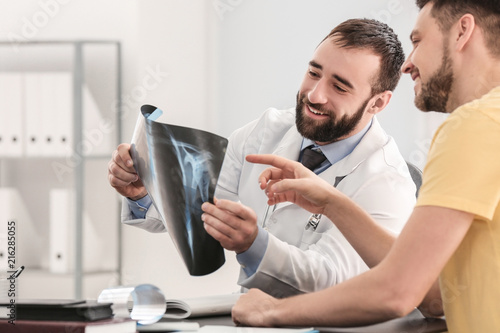 Doctor consulting male pati...