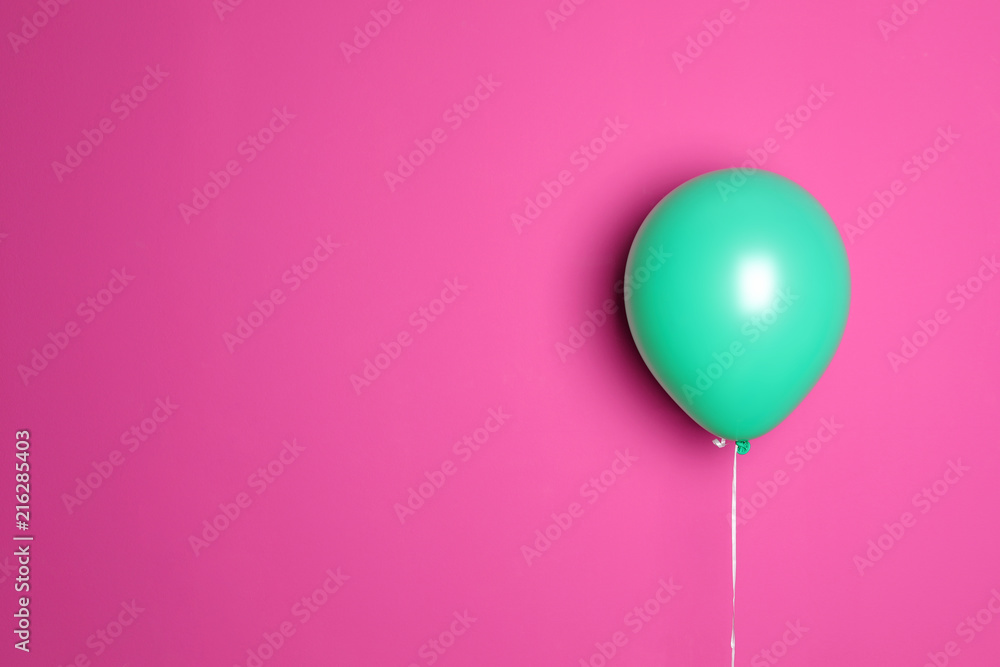 Green balloon on color background. Celebration time