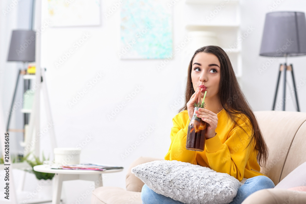 Young woman with tasty refreshing lemonade indoors Young woman with tasty refreshing lemonade indoors