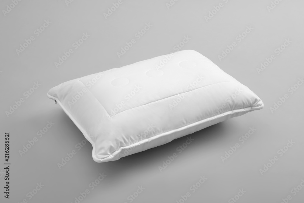 Clean soft bed pillow on grey background Clean soft bed pillow on grey background