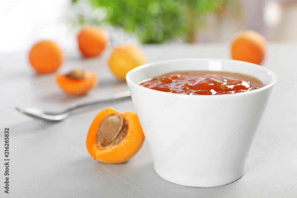 Bowl with tasty apricot jam on table Bowl with tasty apricot jam on table