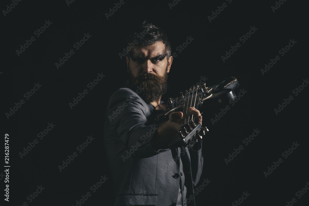 Fototapeta premium Music party and entertainment. Man go to music party. Bearded man with guitar ready to play at music party. Guitarist with musical instrument at music party. Rock is alive