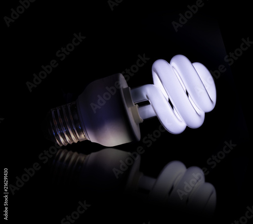 Cold white lightbult on on a black background